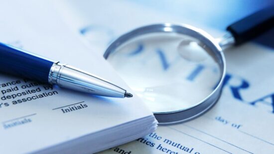 Magnifying-glass-and-pen-on-top-of-contract-GettyImages-1385721977-Med