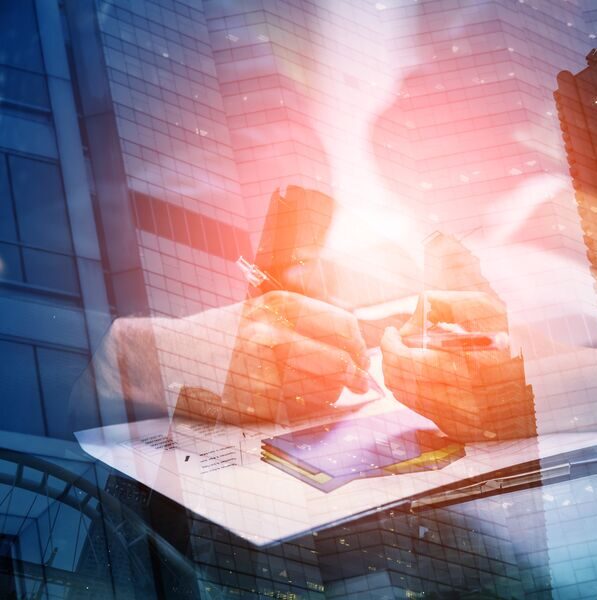 Young-businessman-and-woman-signing-a-paper-in-office-The-concept-of-a-successful-business-GettyImages-1045342822-Med